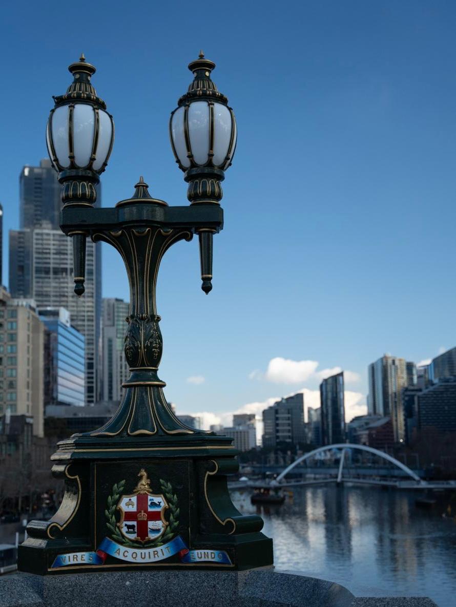 Ornate Southbank lamp post with the Melbourne skyline and Yarra River behind