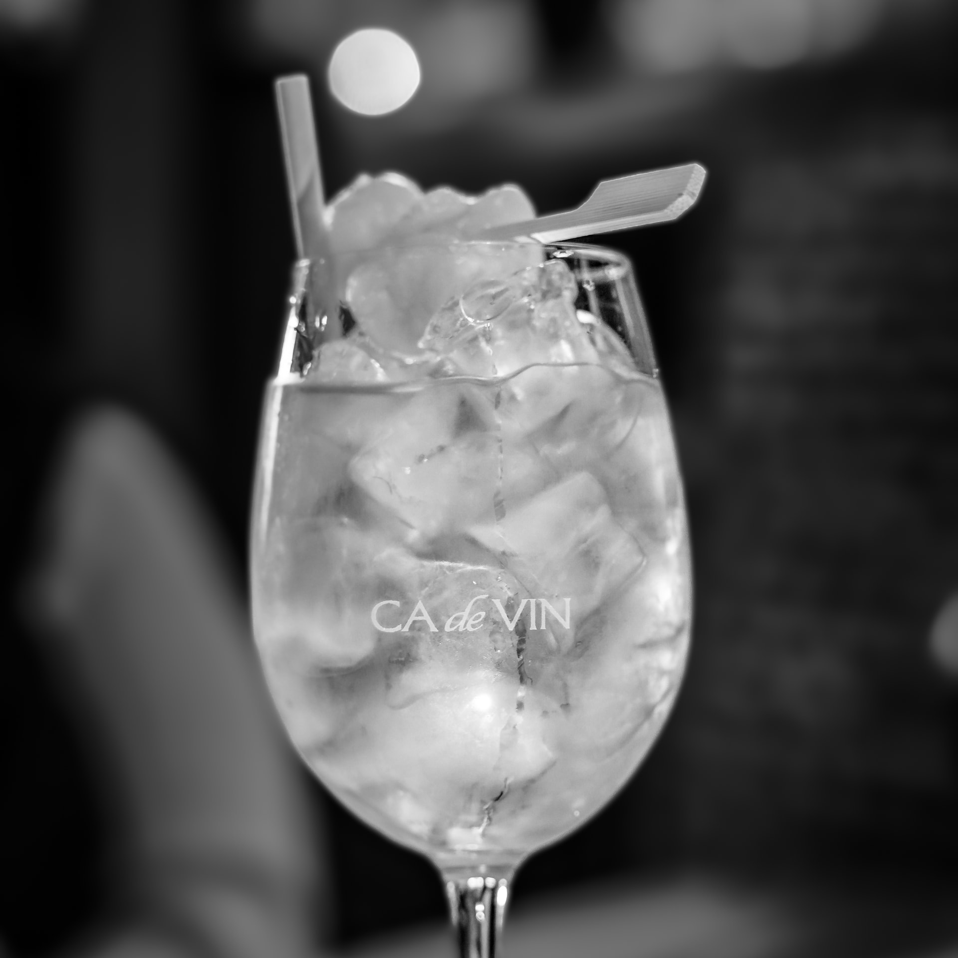 Black and white close-up of a chilled drink in a wine glass