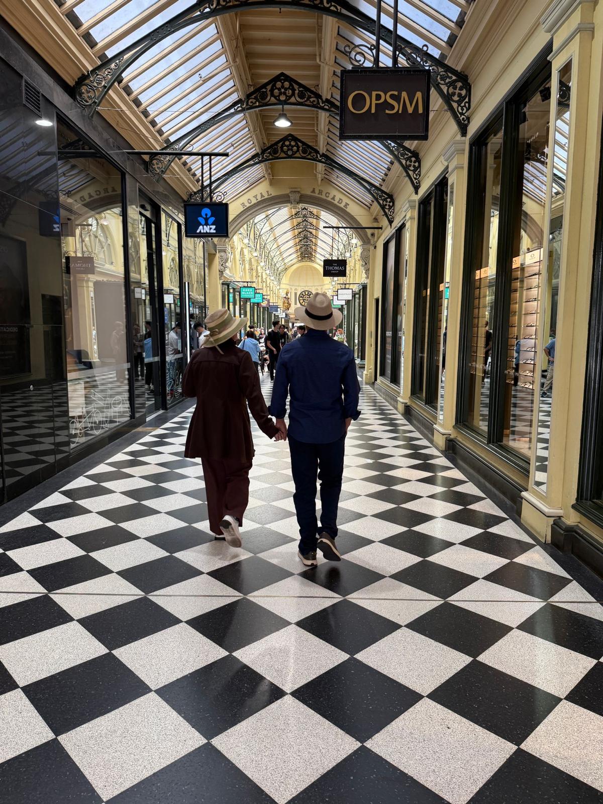 Couple walking hand in hand through Melbourne's Royal Arcade