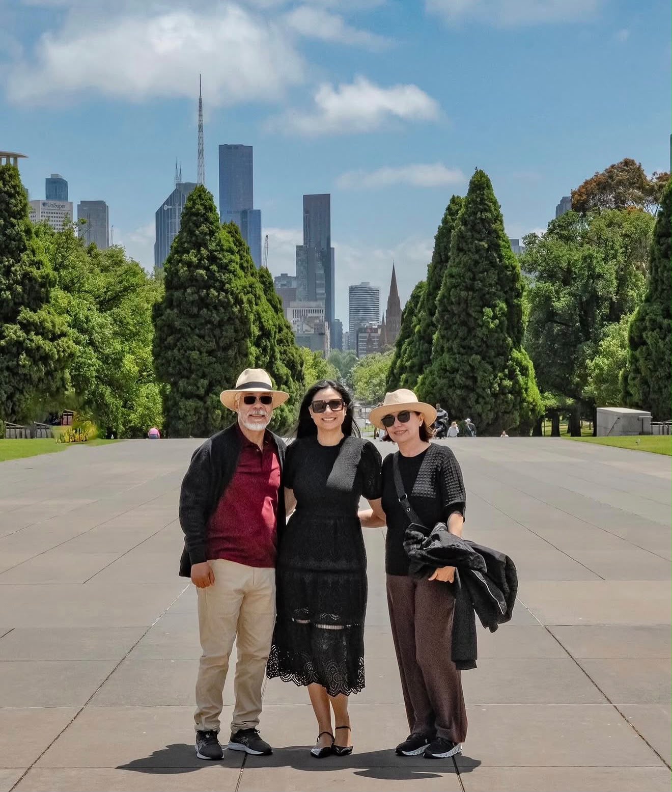 Family portrait with the Melbourne city skyline behind them