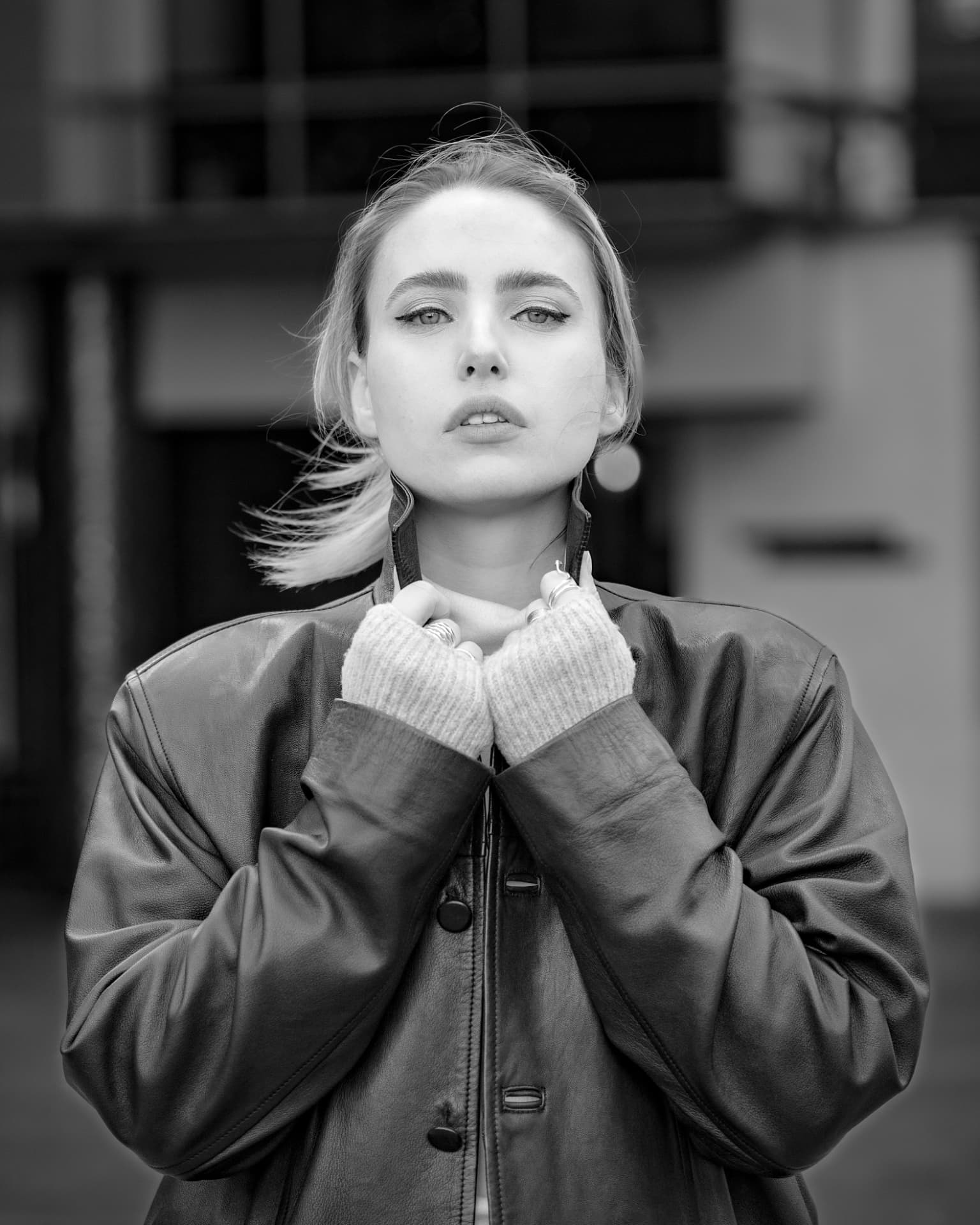 Black and white portrait of a woman in a leather jacket
