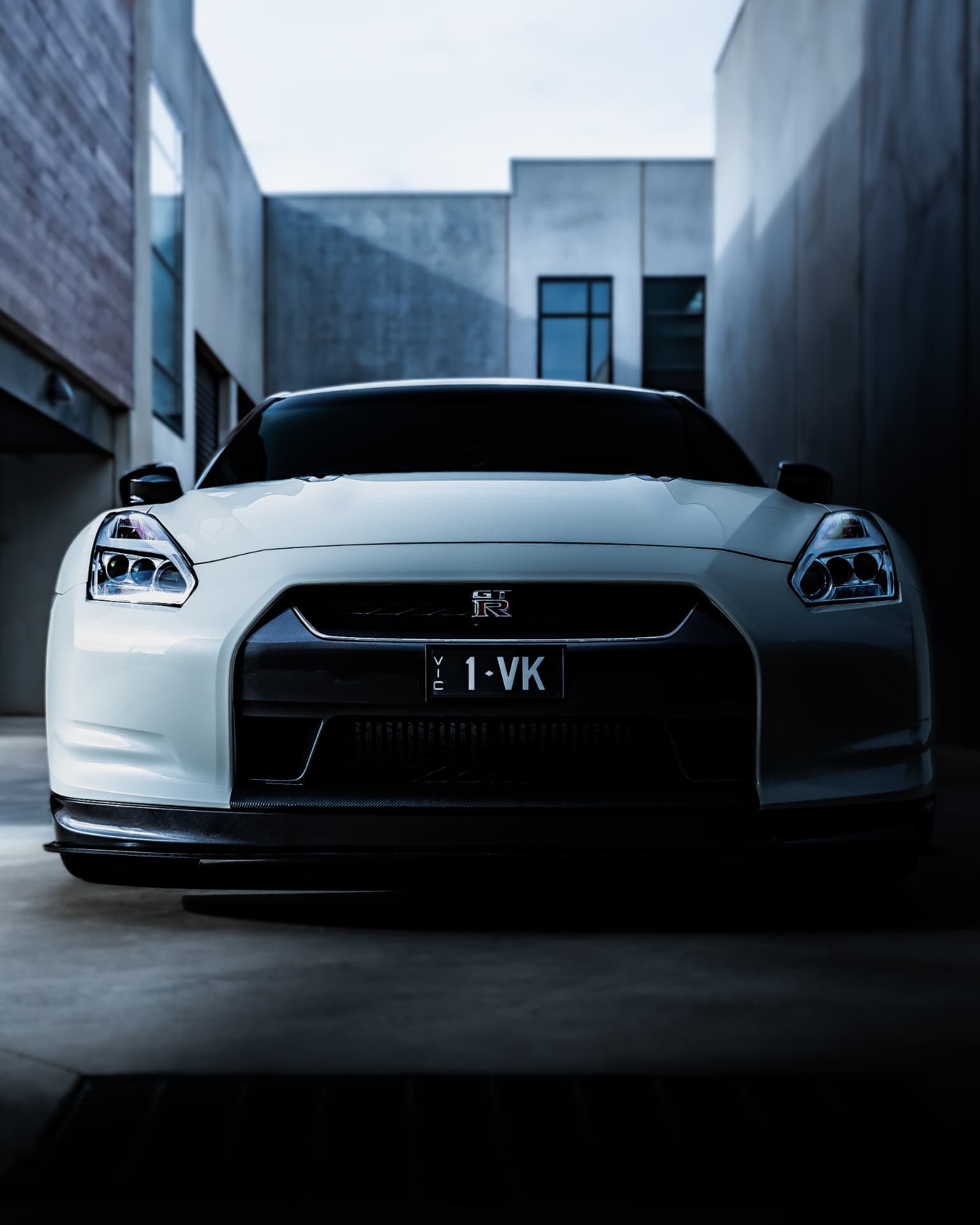 White Nissan GT-R front view in a concrete laneway