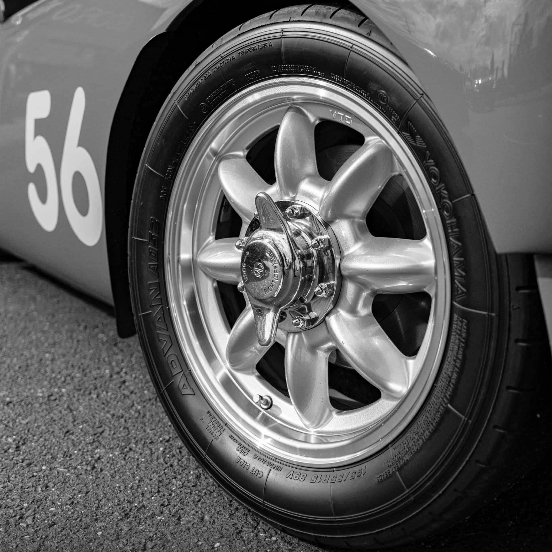 Black and white detail of a classic race car wheel