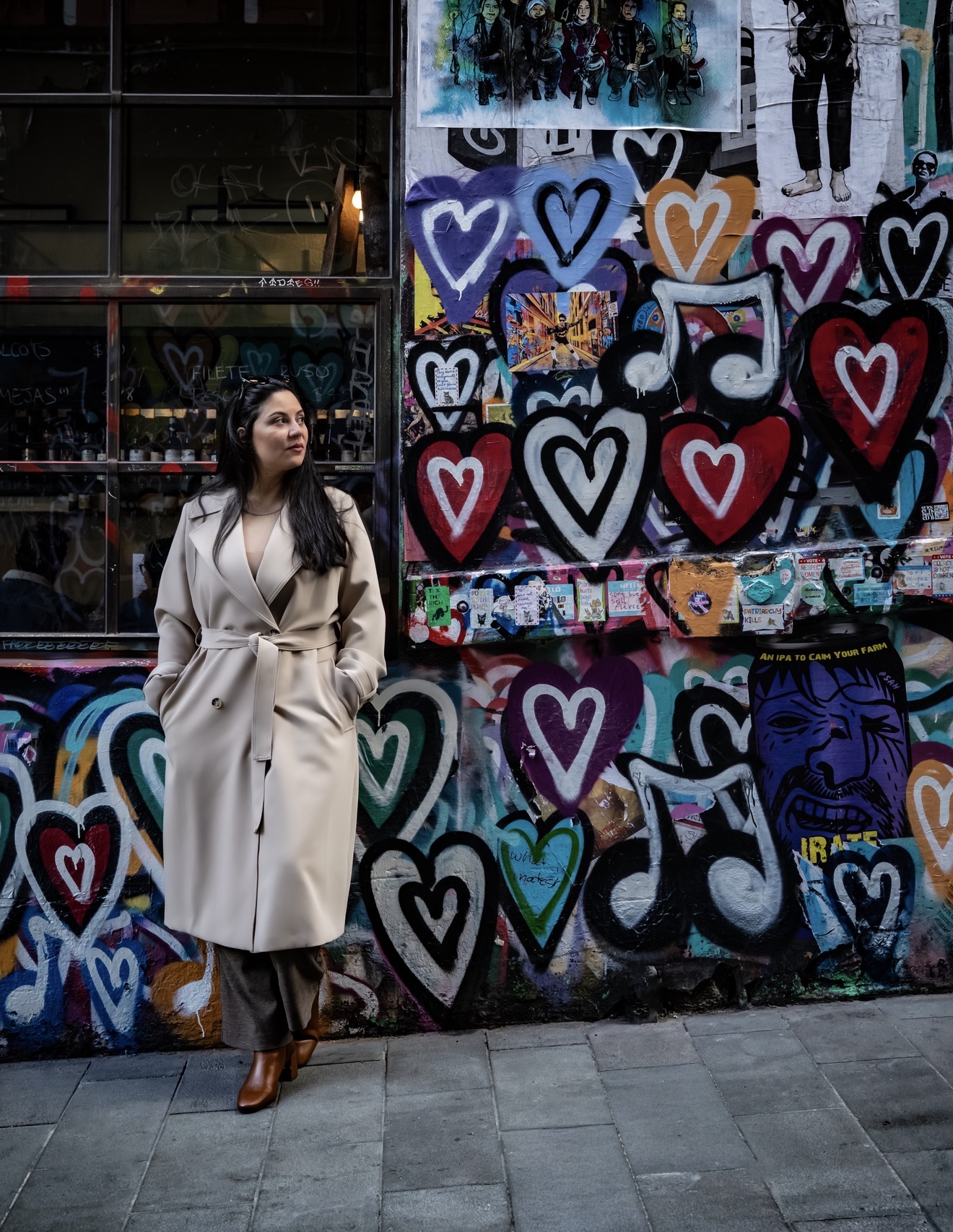 Woman standing confidently in a colourful graffiti-covered Melbourne laneway